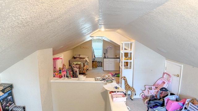 bonus room featuring lofted ceiling, a textured ceiling, and carpet