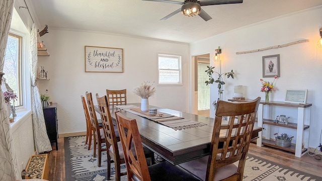 dining area featuring ornamental molding, baseboards, a ceiling fan, and wood finished floors