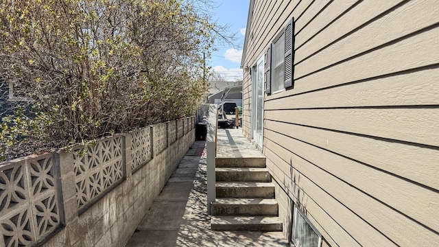 view of side of home with fence