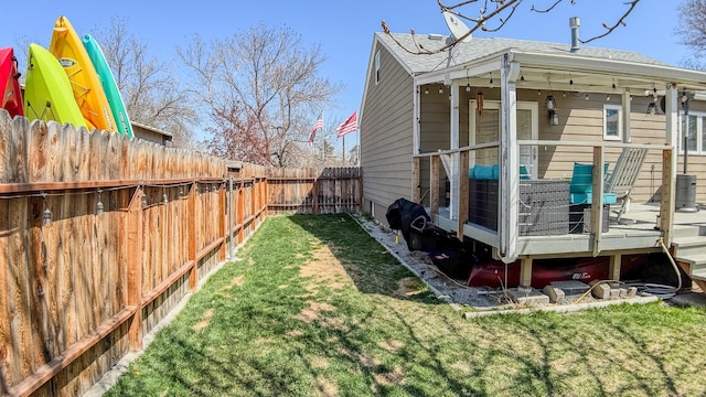 view of side of property with a yard, a deck, roof with shingles, and a fenced backyard