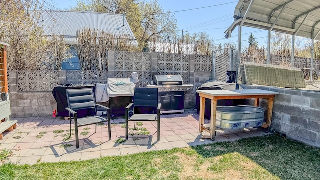 view of patio featuring area for grilling and fence