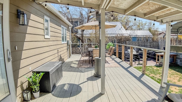 wooden terrace featuring outdoor dining area and fence