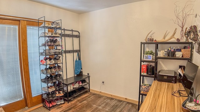 office space featuring baseboards and wood finished floors