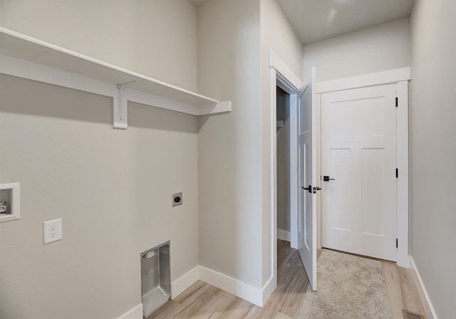 washroom with laundry area, light wood finished floors, hookup for an electric dryer, and baseboards
