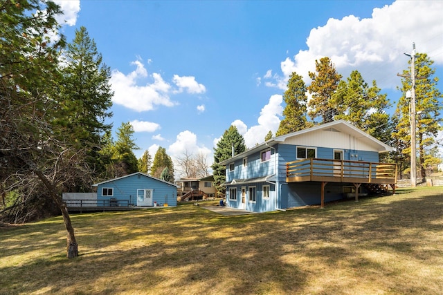172 Holt Dr Unit A, B & C, Bigfork, MT 59911 - back of property featuring a yard and a wooden deck