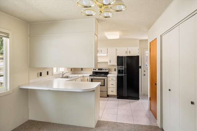 172 Holt Dr Unit A, B & C, Bigfork, MT 59911 - kitchen with a sink, a peninsula, stainless steel electric stove, black refrigerator with ice dispenser, and light countertops