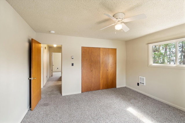 172 Holt Dr Unit A, B & C, Bigfork, MT 59911 - unfurnished bedroom featuring a textured ceiling, carpet flooring, and a closet
