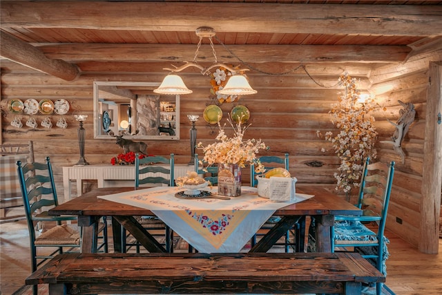 4212 Foothill Rd, Kalispell, MT 59901 - dining area featuring log walls, a wooden ceiling with exposed beams, wood finished floors, and a chandelier