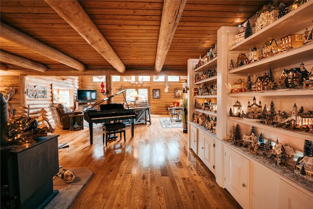 4212 Foothill Rd, Kalispell, MT 59901 - interior space with rustic walls, healthy amount of natural light, a wood ceiling with exposed beams, and hardwood / wood-style floors