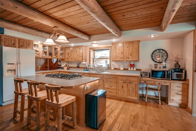 4212 Foothill Rd, Kalispell, MT 59901 - kitchen with appliances with stainless steel finishes, a wood ceiling with exposed beams, light wood-style floors, glass insert cabinets, and light countertops