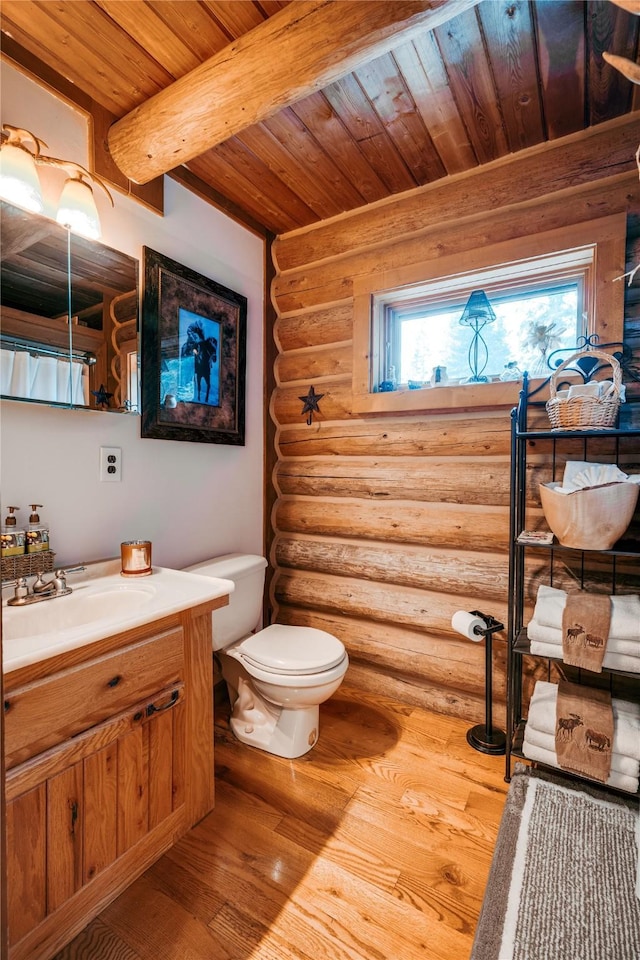bathroom with wooden ceiling, log walls, toilet, and wood finished floors
