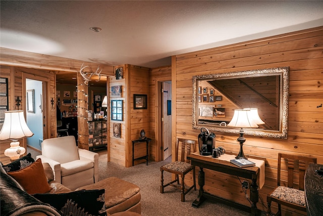 living room featuring wooden walls and carpet