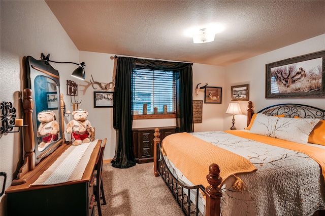 bedroom with light colored carpet and a textured ceiling