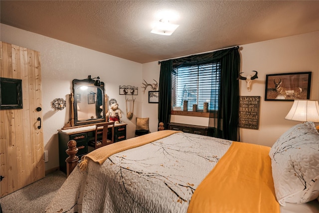bedroom with carpet and a textured ceiling