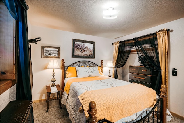bedroom with a textured ceiling, baseboards, and carpet floors