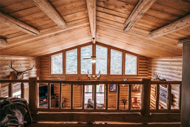 interior space with wood ceiling, rustic walls, and beam ceiling