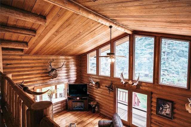 living area featuring wood ceiling, wood-type flooring, vaulted ceiling with beams, and log walls