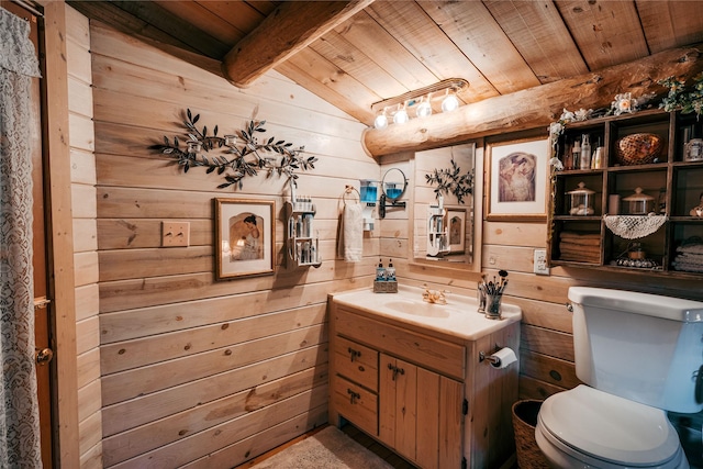 half bathroom featuring wood walls, toilet, beam ceiling, vanity, and wood ceiling