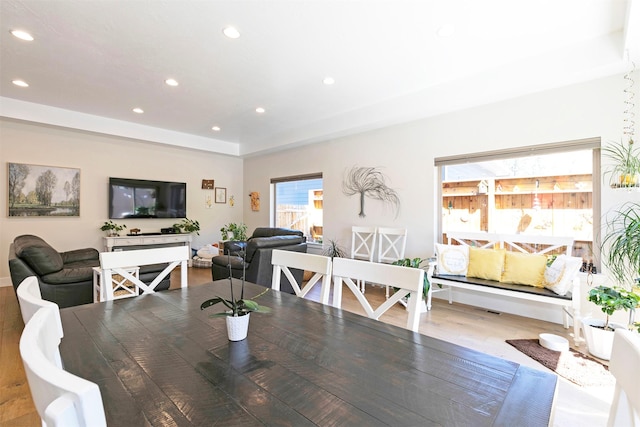 dining area with wood finished floors and recessed lighting