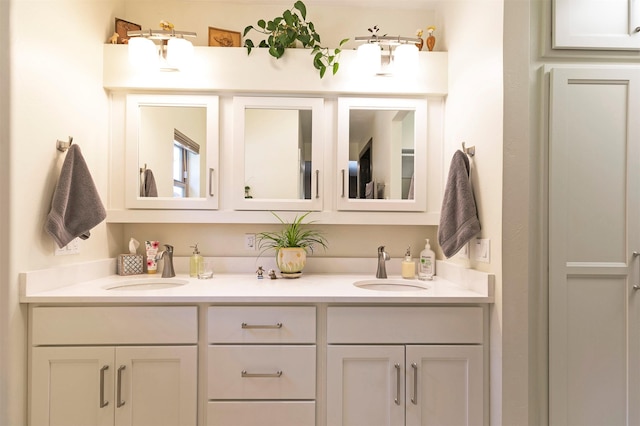 bathroom featuring a sink and double vanity