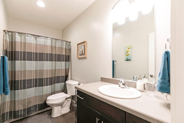 full bathroom with toilet, curtained shower, and vanity