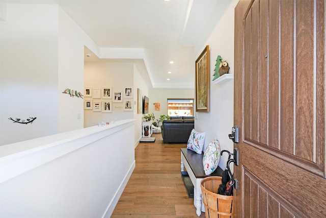 corridor featuring recessed lighting, baseboards, and wood finished floors