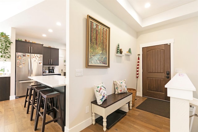 entrance foyer with baseboards, light wood-style floors, and recessed lighting