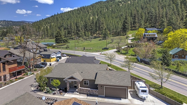 birds eye view of property featuring a mountain view and a wooded view