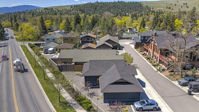 birds eye view of property featuring a residential view, a mountain view, and a view of trees