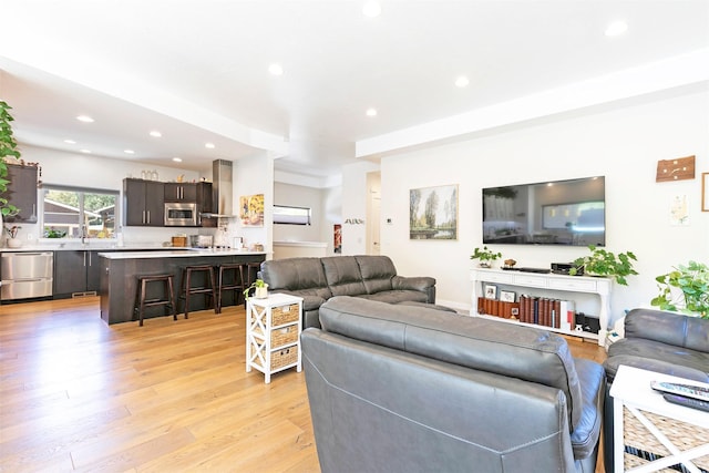 living area featuring light wood-style flooring and recessed lighting
