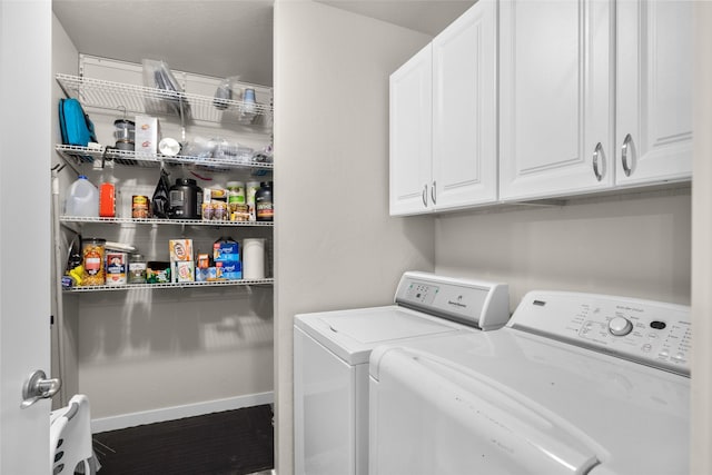 washroom featuring cabinet space, baseboards, and independent washer and dryer