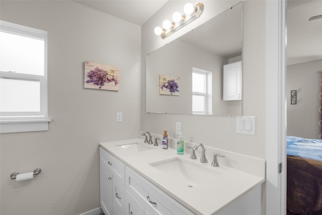 bathroom with double vanity and a sink