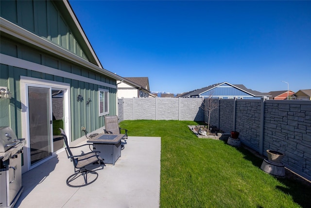 view of yard with an outdoor fire pit, a patio area, and a fenced backyard