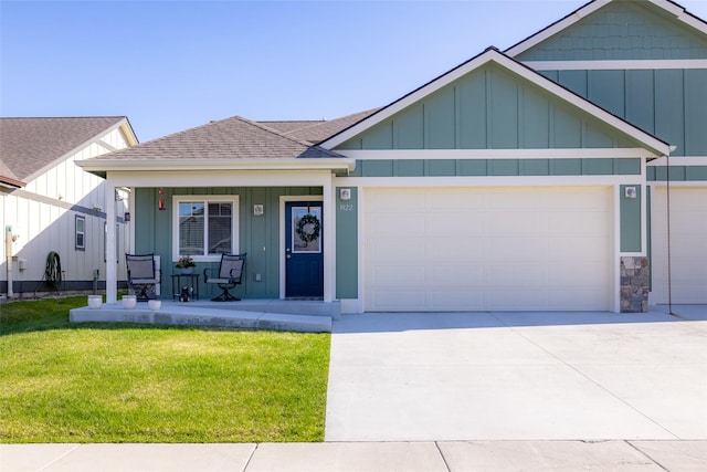 view of front of home featuring a porch, an attached garage, a front lawn, board and batten siding, and a shingled roof