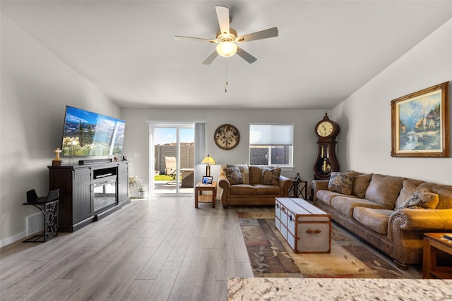 living area with wood finished floors and a ceiling fan