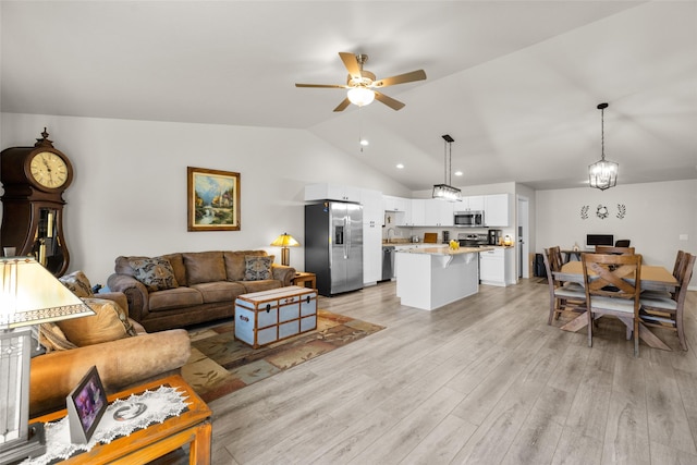 living area with recessed lighting, light wood-style floors, ceiling fan, and vaulted ceiling