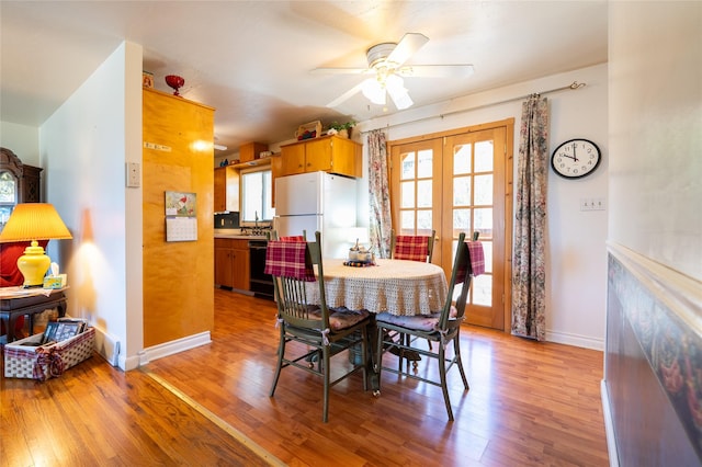 4420 7th Ave S, Great Falls, MT 59405 - dining room featuring a ceiling fan, baseboards, french doors, and light wood-type flooring