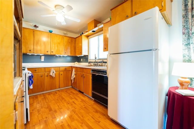 4420 7th Ave S, Great Falls, MT 59405 - kitchen featuring brown cabinetry, freestanding refrigerator, dishwasher, light wood finished floors, and light countertops