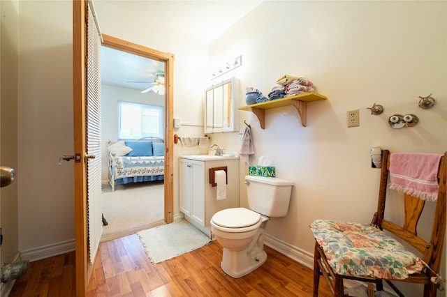 4420 7th Ave S, Great Falls, MT 59405 - ensuite bathroom with wood finished floors, toilet, ceiling fan, baseboards, and vanity