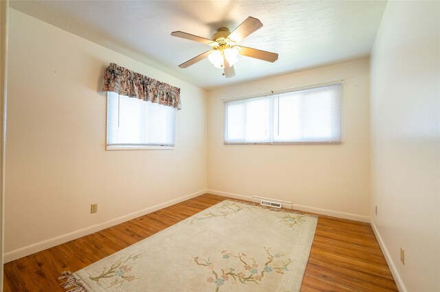 4420 7th Ave S, Great Falls, MT 59405 - empty room with visible vents, wood finished floors, baseboards, and ceiling fan