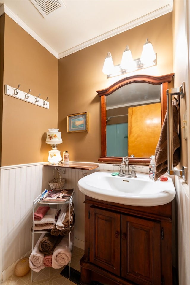 4420 7th Ave S, Great Falls, MT 59405 - bathroom featuring vanity, ornamental molding, and a wainscoted wall