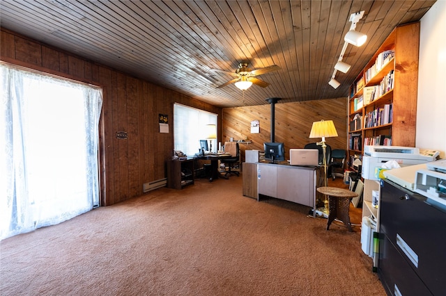 4420 7th Ave S, Great Falls, MT 59405 - carpeted office featuring a ceiling fan, a baseboard radiator, wood walls, and a wood stove