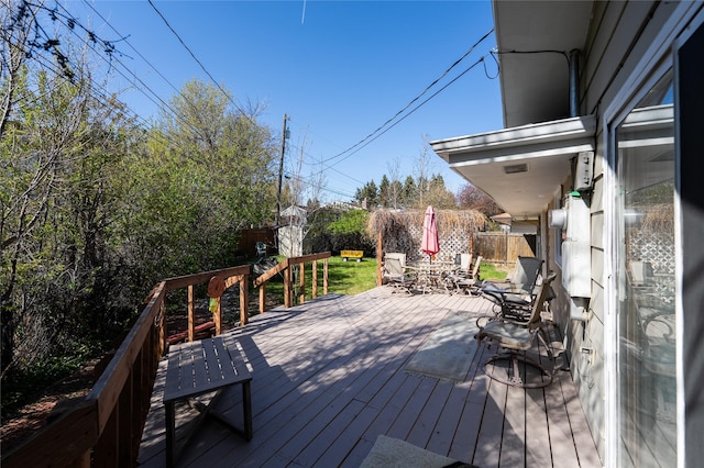 4420 7th Ave S, Great Falls, MT 59405 - wooden deck with a fenced backyard, a storage shed, outdoor dining area, and an outdoor structure