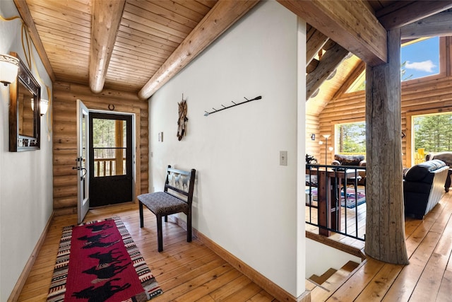 148 Muley Rd, Lakeside, MT 59922 - doorway to outside featuring light wood-style flooring, wood ceiling, baseboards, and log walls