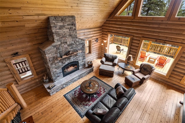 148 Muley Rd, Lakeside, MT 59922 - living area with a towering ceiling, hardwood / wood-style floors, a stone fireplace, and log walls