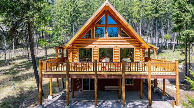 148 Muley Rd, Lakeside, MT 59922 - rear view of property featuring a wooded view, a wooden deck, a patio, and log exterior