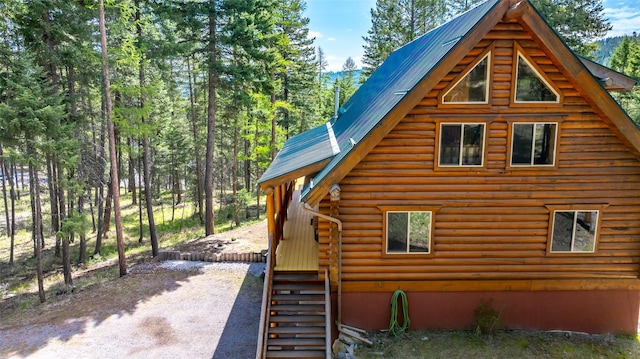 148 Muley Rd, Lakeside, MT 59922 - view of side of property featuring dirt driveway, metal roof, and log exterior