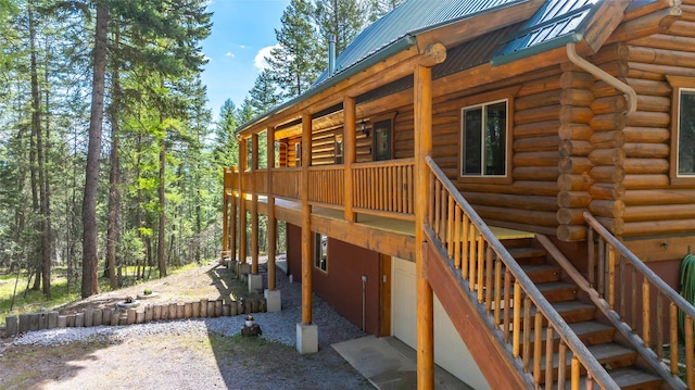 148 Muley Rd, Lakeside, MT 59922 - exterior space featuring a wooden deck, log exterior, metal roof, and stairs