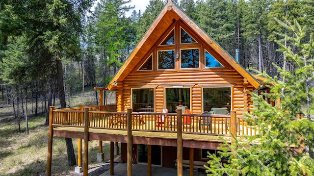 148 Muley Rd, Lakeside, MT 59922 - rear view of property featuring a forest view, log siding, and a deck