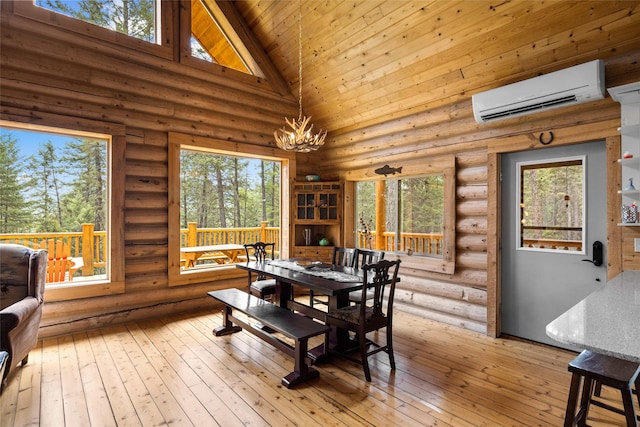 148 Muley Rd, Lakeside, MT 59922 - dining space with a chandelier, a wall mounted AC, high vaulted ceiling, and log walls